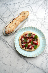 Hummus with baked vegetables, chestnut and pita bread