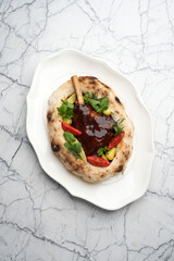 Fried Duck leg with vegetables and sauce in a pita bread