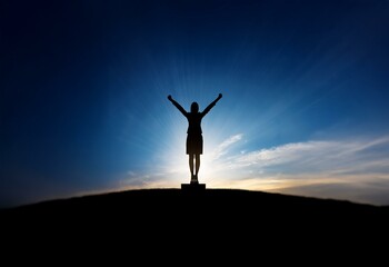 Silhouette of a person with arms raised against a bright blue sky and clouds with rays of light shining down.