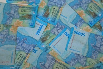 Background of a pile of banknotes with a value of Rp. 50000, with a close up view.