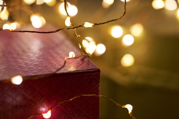 Christmas lights wrapped around a red gift box