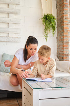 Mother helping her young son with homework