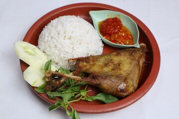 Penyet ayam or fried chicken in Indonesia is the name of a typical Javanese food consisting of fried chicken and chili sauce.