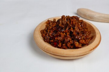 Stir-fried Tempe is a typical Indonesian dish with spices, garlic, shallots, chilies and soy sauce. served on a wooden plate