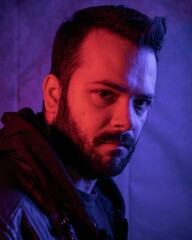 Brazilian Man in black hooded jacket with soft studio lighting highlighting the jacket's texture