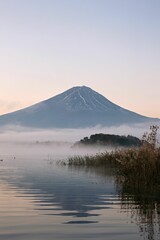 Mount Fuji at dawn with mist over the lake