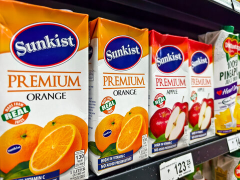 Variety of premium fruit juice cartons on supermarket shelf