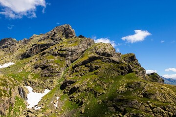 Stunning mountain landscape with patches of snow against a clear blue sky