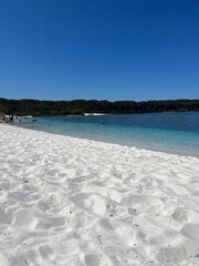 Bright White Sand of Lake McKenzie, Fraser Island, on a sunny day with blue clear sky in Australia