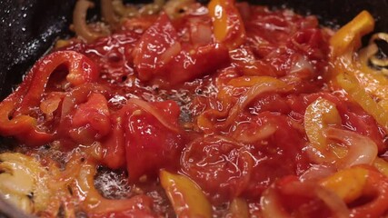 Close up footage of frying the red and yellow bell pepper slices in a frying wok - Powered by Adobe