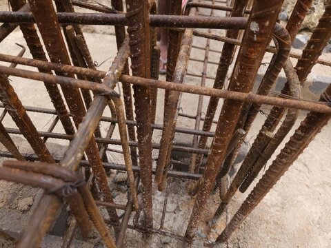 Photography, construction workers using reinforced tmt steel bar with ease at the construction site, Reinforced bar (rebar). TMT steel rods tied together forming the core of concrete