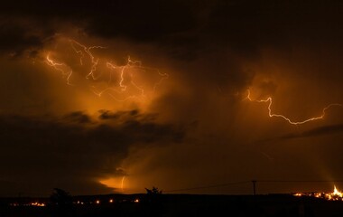 Dramatic night sky with lightning during a thunderstorm.
