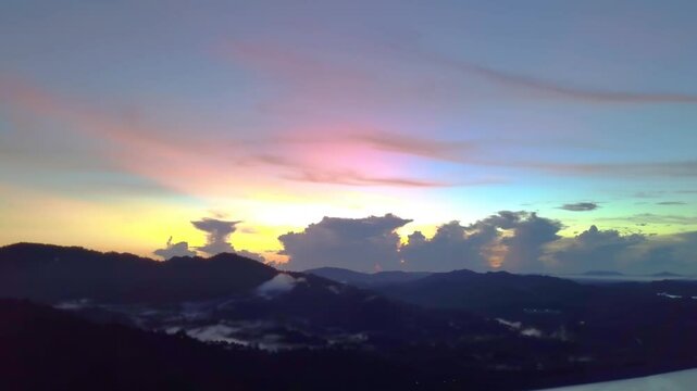 In Terengganu, Malaysia, an aerial zoom-out view shows a vibrant sunrise close to Lake Kenyir.