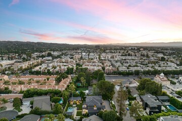 Aerial view of suburban neighborhood at sunset.