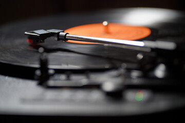 A vinyl record placed on a music player to listen to music