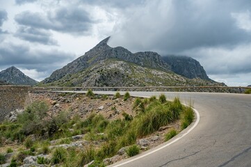 Scenic mountain road with dramatic clouds