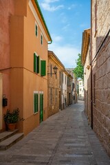 Charming Mediterranean village street with colorful buildings.