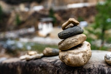 Close-up of stacked stones with a blurred natural background
