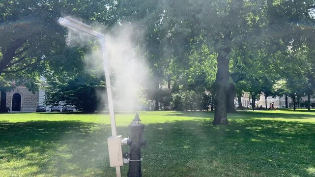 Water dispenser connected to a fire hydrant in a garden to fight the heatwave in summer