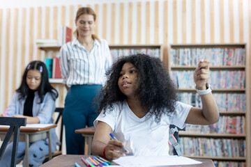 African American school girl, afro hairstyle. Studying in classroom. Back to school concept. Learning in system, education.