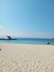 Serene beach with clear blue water and white sand