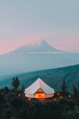 Stunning glamping setup with mountain backdrop during twilight