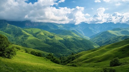 Obraz premium Lush green mountains under a bright sky with clouds.