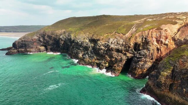Aerial view of cliffs overlooking sea on a sunny day at St Agnes Heritage Coast in Cornwall, UK