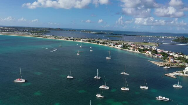 Drone view over moored boats on the ocean, on a sunny day with blue sky in Simpson Bay, Sint Maarten