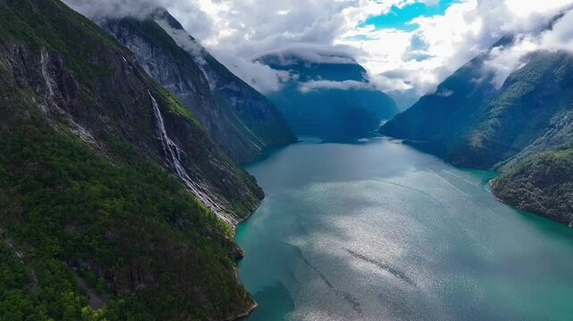 the Seven Sisters Waterfall flowing on mountain over a river along the Geirangerfjorden