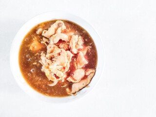 Chinese style chicken gravy sauce in a white bowl. Top view..