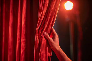 Generative AI hand unveiling theater stage with spotlight