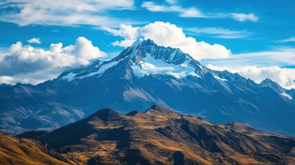 Fototapeta premium Majestic Snow-Capped Mountain Peak Rising Above Lush Green Hills