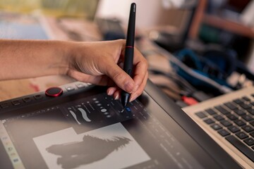 Young woman drawing on a digital tablet. Female graphic designer working from home