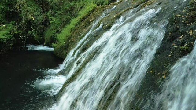 Drone pullback of Parga Waterfall with greenery in the background in Zas Water Route