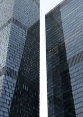 Obraz premium Two skyscrapers with reflection of another building. Minimalistic abstract city photography