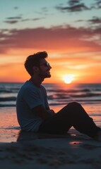 Man smiles at sunset on beach.