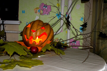 pumpkin with prose lights up on Halloween, branch, candles, autumn leaves, decoration, party,...