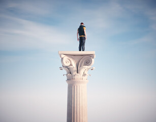 Man standing on a Roman column.