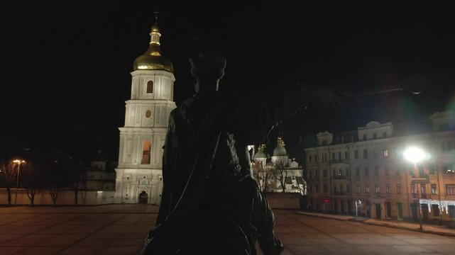 Drone of the Bohdan Khmelnytsky statue with Saint Sofia cathedral in front of it at night in Kyiv