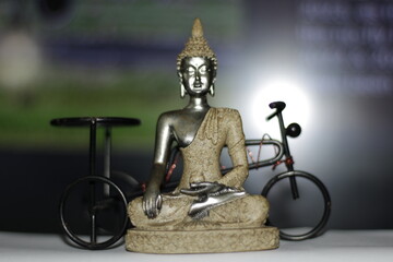Serene Buddha Statue on empty colorful backdrop with copy space, yoga, meditation and relaxation...