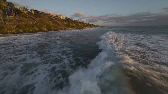 Drone footage of ocean waves on Moonlight State Beach at sunset in Encinitas, California