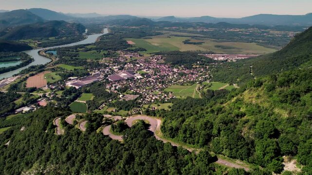 Ascending aerial footage of the Lacets du Grand Colombier and the town of Culoz, Ain, France