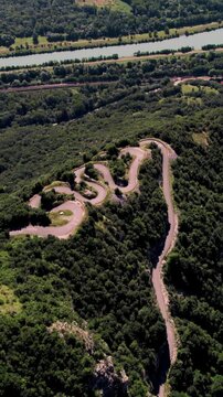 Aerial vertical footage of Lacets du Grand Colombier, and Rhone River in Culoz town, Ain, France