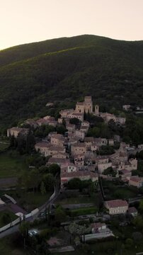 Aerial vertical footage of Le Poet-Laval rural commune at sunset in the Drome department, France
