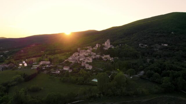 Aerial footage of Le Poet-Laval rural commune at sunset in the Drome department, southeastern France
