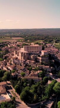 Vertical aerial footage of Grignan commune on a sunny day in the Drome department, France