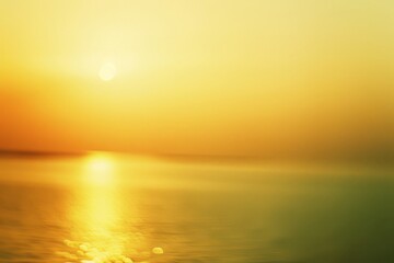 A serene sunset casts a warm golden glow over tranquil waters, creating a soothing and dreamy atmosphere.