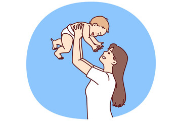 Mother lifts baby above head, rejoicing at birth son and celebrating arrival of new family member. Girl with newborn is happy that has become mother and throws up baby to hear children laughter