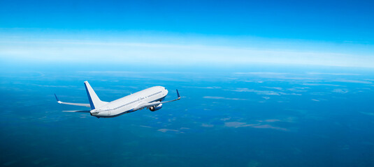Airplane flying in the sky over the sea, travel panoramic background with modern white airplane...
